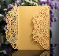 Detail of laser-cut golden mandala pearl paper wedding invitation cover with intricate hollow pattern - Gold