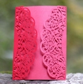 Detail of red laser-cut hollow card with intricate floral patterns on a wooden stand - Red