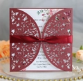 Detail of burgundy laser-cut floral wedding invitation with silk bow and pink rose insert - Dark Red