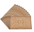 Macro detail of laser-cut vintage floral pattern on brown kraft paper invitation card - Beige Gold