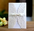 Elegant ivory laser-cut wedding invitation with intricate floral lace and satin bow - Ivory