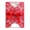 Macro view of laser-cut wedding invitation featuring intricate floral patterns and red ribbon - Pearlescent Red