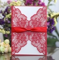 Elegant red laser-cut wedding invitation with butterfly patterns and a silk ribbon bow - Pearlescent Red