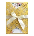 Macro shot of laser-cut pocket and pearl gold paper invitation with floral patterns - Gold Yellow