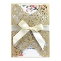 Detailed laser-cut vine patterns on gold wedding invitation with satin ribbon bow - Beige Gold
