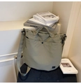 Détail du sac fourre-tout en toile vert olive montrant la poche à bouton et la bandoulière - Vert