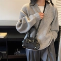 Vintage black shell bag with gold studs and rivets, worn by model for daily fashion look - Black