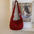 Deep red high-density canvas dumpling bag with adjustable strap and zip pocket detail - Red