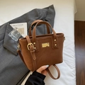 Brown textured synthetic leather bucket bag with gold-tone hardware and top handles - Brown No Pendant