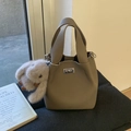 Borsa a secchiello in pelle martellata kaki con chiusura a scatto e peluche - Con Ciondolo / Grigio elefante