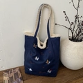 Bolso tipo cubo de lona azul con borde de felpa crema y bordado de caballito - Azul