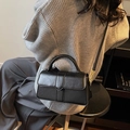 Fashionable black glossy leather crossbody bag with V-shaped metal trim and top handle - Black