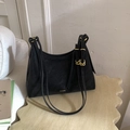 Detalle de bolso medialuna de cuero negro con correas finas y hebillas doradas - Negro