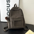 Detail of vintage suede backpack in dark grey with white contrast stitching and plush charm - With Charm / Coffee