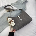 Chic dark gray half-moon shoulder bag in matte finish with a cute plush bear charm - Gray