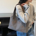 Gray canvas tote bag with brown leather handles and TAOCAITU embossed letter patch - Dark Brown
