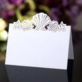 White laser cut place card with starfish and seashell patterns for ocean themed weddings - White