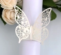 Detail of laser-cut butterfly napkin ring in pearl white with floral hollow patterns - Ivory