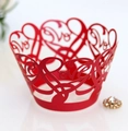 Macro shot of red laser-cut cupcake wrappers with elegant 'Love' heart pattern - Pearlescent Red