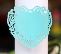 Macro shot of laser-cut light blue heart napkin ring with floral vine pattern - Light Blue