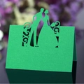 Grass green laser-cut wedding place card featuring a hollow bride and groom silhouette - Dark Green