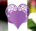 Detail of purple laser-cut heart napkin ring with intricate scroll patterns and texture - Dark Purple