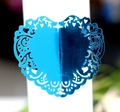 Detail of laser-cut heart napkin ring in bright blue with intricate vine patterns - Reflective Blue