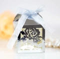 Close-up of laser-cut rose hollow favor box with silver mirror finish and blue ribbon bow - Reflective Silver