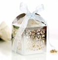Macro shot of laser-cut hollow floral patterns on a silver wedding favor candy box - Reflective Silver