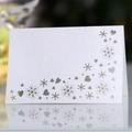 White laser-cut place card with snowflake and heart patterns on pearlescent paper - White