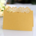 Elegant gold pearl paper wedding place card featuring laser-cut floral hollow design - Gold