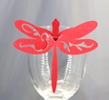 Macro detail of laser-cut red glitter paper dragonfly card for wedding glass decor - Red