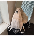 Detail of cream pleated crossbody bag showing metallic logo and side buckle design - Off White