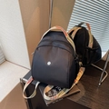 Zaino in nylon nero multi-tasche con tracolla intrecciata in stile etnico colorato - Nero a Contrasto