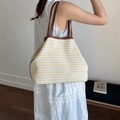 Grande borsa tote in tela a righe gialle con manici in pelle marrone su modella - Giallo