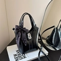 Glossy black bucket bag with silver lock and polka dot scarf detail in high fashion style - Black