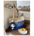 Detailed close-up of a three-tone knit tote bag featuring a hollow mesh weave and seagull charm - With Pendant / Blue Color Block