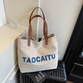 Off-white canvas tote bag with blue TAOCAITU embroidery and brown leather straps - Beige Grey