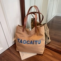 Khaki canvas tote bag with blue embroidered letters and brown leather handles - Caramel color