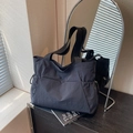 Minimalist black nylon tote bag with functional drawstring side pockets for daily commute - Black