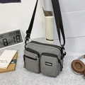 Modern grey waterproof nylon crossbody bag with multiple zip pockets and adjustable strap - Gray