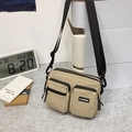 Beige nylon crossbody bag with multi-pocket utility design and adjustable black strap - Khaki