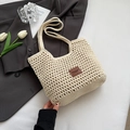 Close-up of beige crochet woven tote bag featuring a premium brown leather logo patch - With Label Small