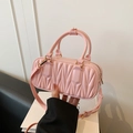 Pink quilted crossbody bag with golden hardware and glossy matelassé texture - Pink