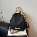 Black nylon backpack with cream leather handle and colorful striped crossbody strap - Black