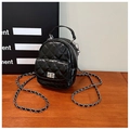 Detailed macro view of black quilted glossy leather mini bag with silver rotating lock - Black
