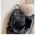 Detail of black pebbled leather backpack with silver zippers and multi-compartment design - Black