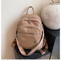 Detail view of khaki faux leather backpack with patterned wide shoulder strap - Brown