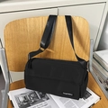Minimalist black canvas cylinder crossbody bag with adjustable wide shoulder strap - Black