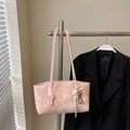 Borsa sottobraccio rosa con trama marmorea e fiocco bianco appesa a un supporto - Rosa con ciondolo